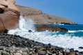 great shot of the coast with beautiful blue water and the surf hitting the rocks