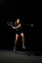 great shot of healthy woman with tennis racket in her hand bouncing to hit the tennis ball. Royalty Free Stock Photo