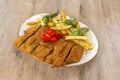 Great Spanish recipe for cachopo with red piquillo peppers, homemade chips Royalty Free Stock Photo