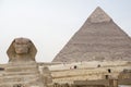 Great Sphinx on the background of the pyramid of Khafre. Cairo Royalty Free Stock Photo