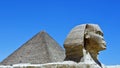 The Great Sphinx of Ghiza with a pyramid in the background. Royalty Free Stock Photo