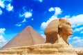 The Great Sphinx and Khafre Pyramid in Giza against blue cloudy sky in Giza, Cairo, Egypt Royalty Free Stock Photo