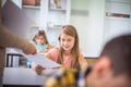 Teens in class. The teacher gives them control tasks