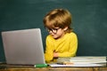 Great study achievement. Classroom. Blackboard background - copy space. Happy smiling pupils drawing at the desk.