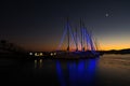 great sunset in the harbor, boats and sailboats tied to the dock, reflections, Volos, Greece