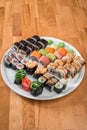 Great sushi set. Rolls with salmon, eel, avocado and tuna on a white plate. Japanese cuisine Royalty Free Stock Photo