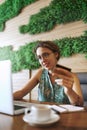 A great tool for growing a small business. a young woman using a laptop and credit card while working at a cafe. Royalty Free Stock Photo