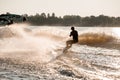 Great view of active man riding wakeboard behind motor boat on splashing river waves. Active and extreme sports Royalty Free Stock Photo