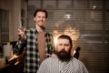 great view of bearded man client and male barber with comb and scissors Royalty Free Stock Photo