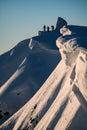 great view of beautiful relief snow-covered mountain slope and freeriding skiers on it Royalty Free Stock Photo