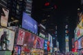 Great view of colorful illuminated skyscrapers against night sky near red staircase on Broadway. Manhattan.