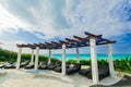 Great view of Golden Tulip hotel swimming pool area with comfortable sun beds near the beach and tranquil turquoise ocean