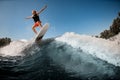 Great view of man jumping over river wave on board against sunny blue sky. Royalty Free Stock Photo