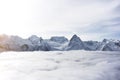 Great view of the massive snowy mountains. Amazing winter rocks above the cloud Royalty Free Stock Photo