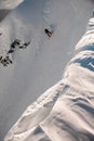 Great view of mountain slope covered with white powdery snow along which freerider on snowboard moves down Royalty Free Stock Photo