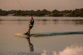 great view of muscular man holding the handle with cable and rolls on water on wakeboard