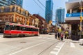 Great view of old street car with fragment of old and modern buildings, walking people in background Royalty Free Stock Photo