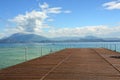 Great view of pier on Lake Garda from Sirmione beach, Italy