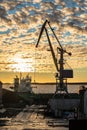 Russia, Vyborg, November 2020. A ship and a crane in the port at sunset.