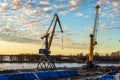 Russia, Vyborg, November 2020. Cranes of the city port at sunset.