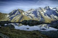 Great view of small lake in Gran Paradiso National Park, Alps, Italy, beautiful world. calm scenery with mountains covered by sn Royalty Free Stock Photo