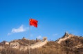 Great Wall of China with Chinese flag waving against a blue sky Royalty Free Stock Photo