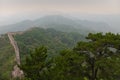 Great Wall of China across the green forest on a misty day Royalty Free Stock Photo