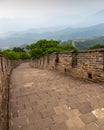 Great Wall of China surrounded by mountains on a foggy day Royalty Free Stock Photo