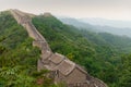 Green forest surrounding the Great Wall of China on a foggy day Royalty Free Stock Photo