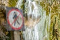 The Great Waterfall and a No tresspassing, no Crossing and do not enter Sign Standing Alone in the Front of the Flowing Waters