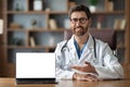 Great Website. Friendly Doctor Man Pointing At Laptop With Blank White Screen