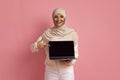 Great Website. Happy Muslim Woman In Hijab Pointing At Blank Laptop Screen Royalty Free Stock Photo