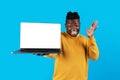 Great Website. Surprised Black Man Holding Laptop Computer With Blank White Screen Royalty Free Stock Photo