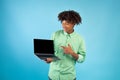 Great website. Teen african american guy showing laptop computer blank screen, standing over blue background Royalty Free Stock Photo