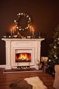 Great white fireplace decorated with many candles Royalty Free Stock Photo