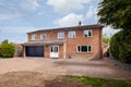 Suburban detached house with large parking area and block paving