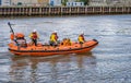 The inshore RNLI inflatable RIB lifeboat cruising up the River Yare in the seaside town of Great Yarmouth