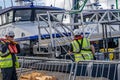 Crew of a passenger service boat mooring their vessel to the harbour wall