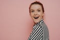 Greatly surpirsed brunette teen girl in striped shirt