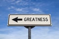 Greatness road sign, arrow on blue sky background Royalty Free Stock Photo