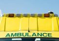 Gree AMBULANCE sign on yellow NHS vehicle. Royalty Free Stock Photo