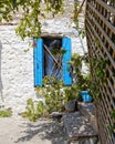Greece, blue window shutters on traditional Mykonos house white washed stone wall Royalty Free Stock Photo
