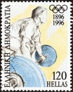 GREECE - CIRCA 1996: A stamp printed in Greece from the `Modern Olympic games centenary` issue shows a weightlifter , circa 1996.
