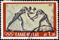 GREECE - CIRCA 1972: A stamp printed in Greece shows ancient wrestlers bas-relief, circa 1972.