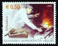 GREECE - CIRCA 2003: A stamp printed in Greece from the `Professions` issue shows Ironsmith, circa 2003. Royalty Free Stock Photo
