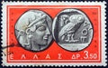 GREECE - CIRCA 1963: A stamp printed in Greece shows a coin from Athens, 5th century B.C. Athena`s head and owl, circa 1963. Royalty Free Stock Photo