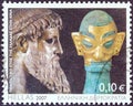 GREECE - CIRCA 2007: A stamp printed in Greece shows Zeus of Artemision statue and bronze head sculpture with golden mask.