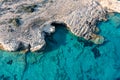 Greece, Cyclades. Aerial drone view of steep rocky coastline over green emerand sea water Royalty Free Stock Photo