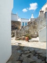 Greece Cyclades, Tinos island Volax village. Old stonewalls between whitewashed buildings. Vertical Royalty Free Stock Photo