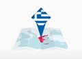 Greece is depicted on a folded paper map and pinned location marker with flag of Greece Royalty Free Stock Photo